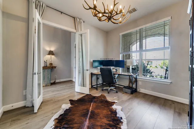 a view of a workspace with furniture and a window