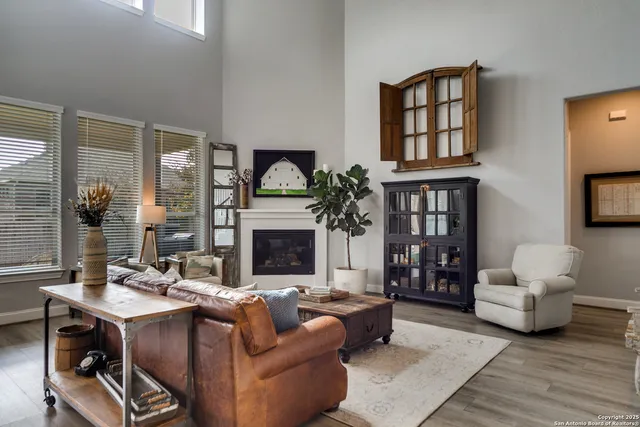 a living room with furniture a fireplace and a flat screen tv