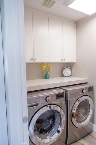 a close view of staircase with washer and dryer