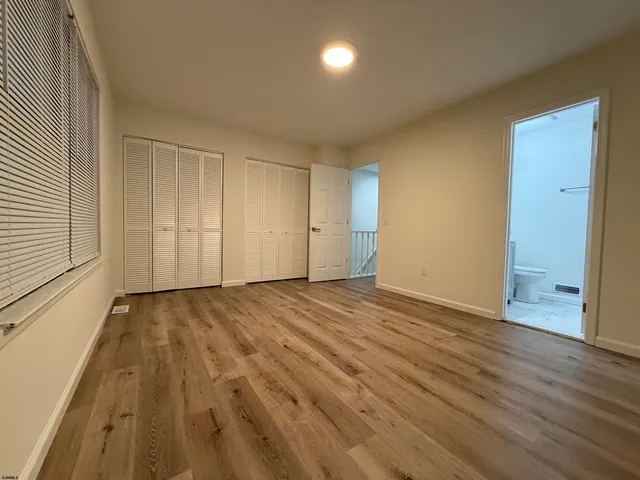 a view of an empty room and wooden floor