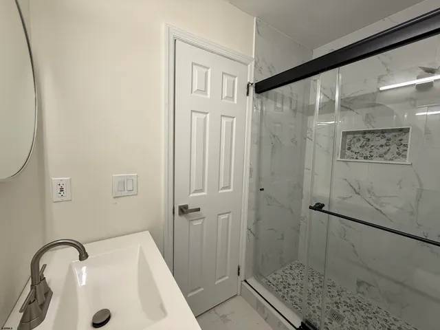a bathroom with a sink and shower