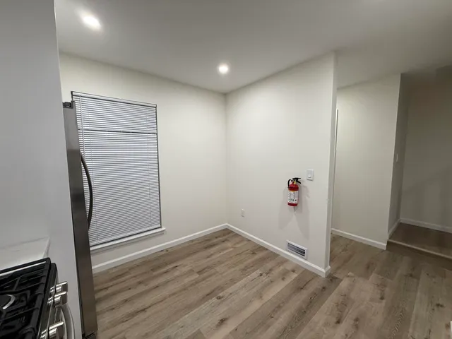 an empty room with wooden floor and closet