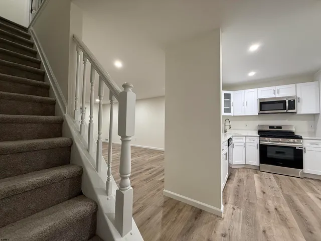 a view of a kitchen with microwave and cabinets