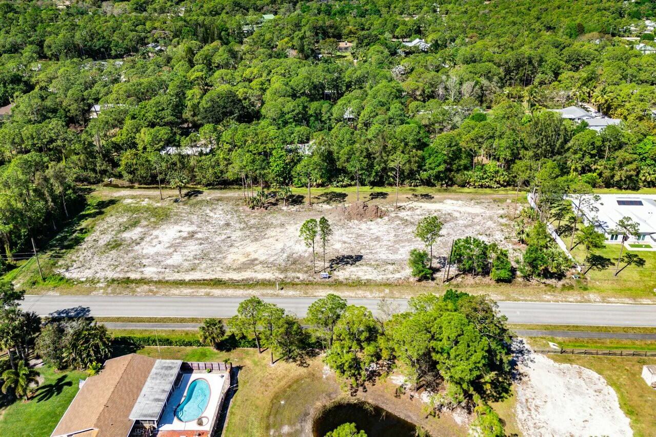 7160 Mellen Lane North Jupiter, FL 33478 - Photo 14 of 15 a view of a lake with a yard