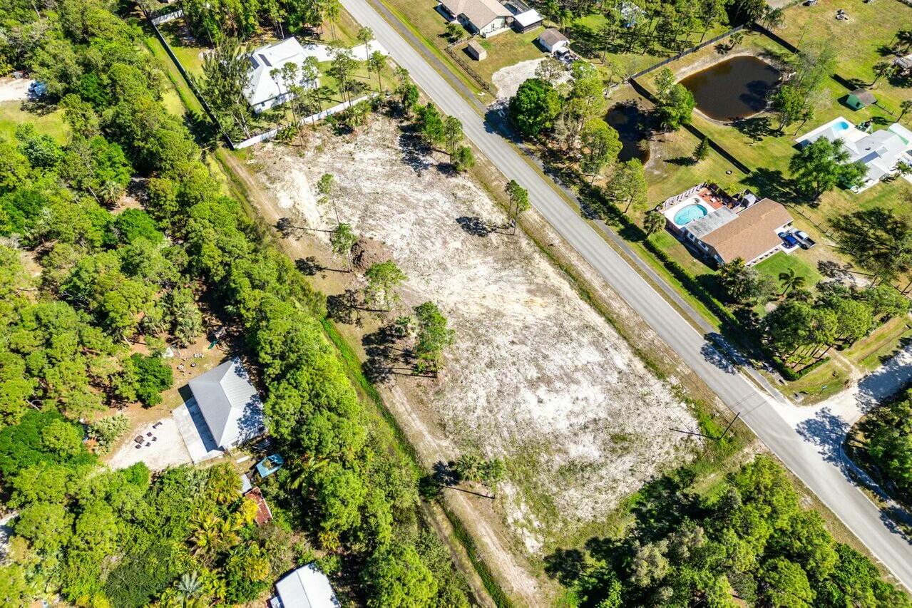 7160 Mellen Lane North Jupiter, FL 33478 - Photo 3 of 15 an aerial view of residential houses with outdoor space