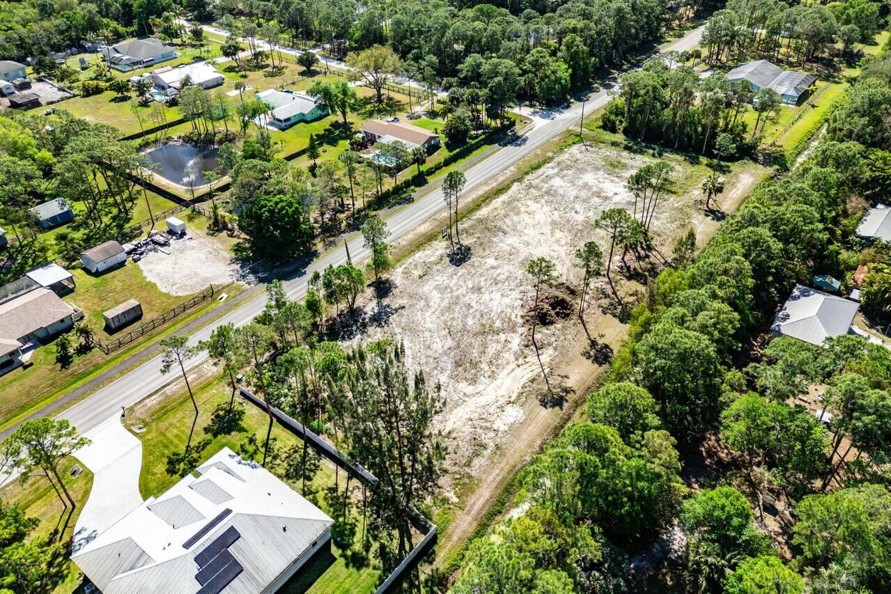 7160 Mellen Lane North Jupiter, FL 33478 - Photo 9 of 15 an aerial view of a house with a yard and plants