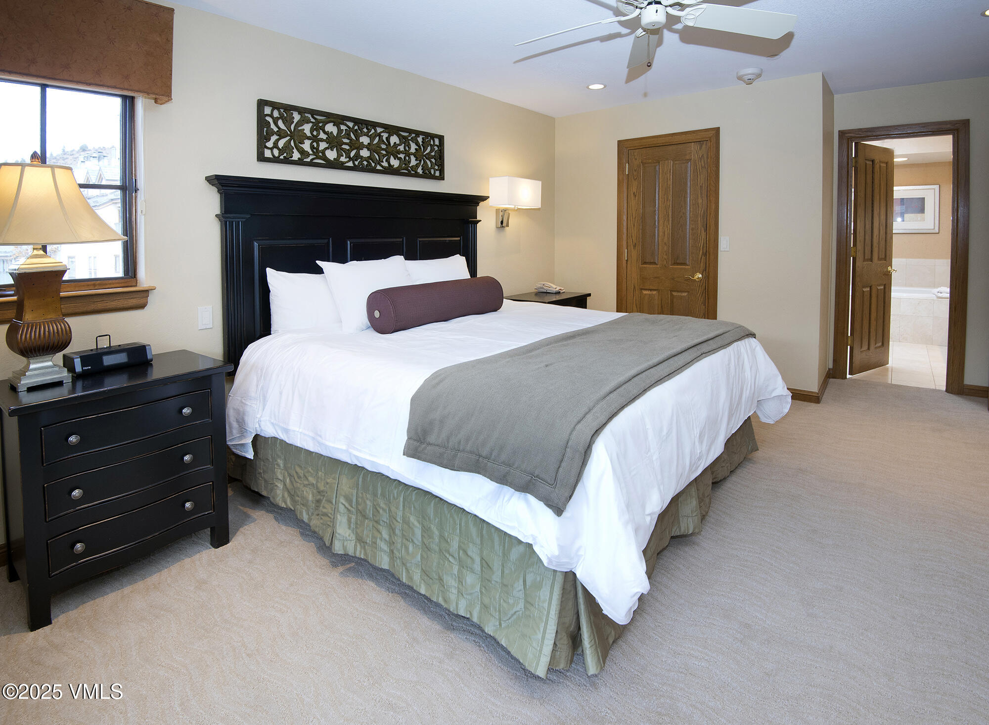 210 Offerson Road, Unit 321 Beaver Creek, CO 81620 - Photo 23 of 30 a bed sitting in a bedroom next to a window