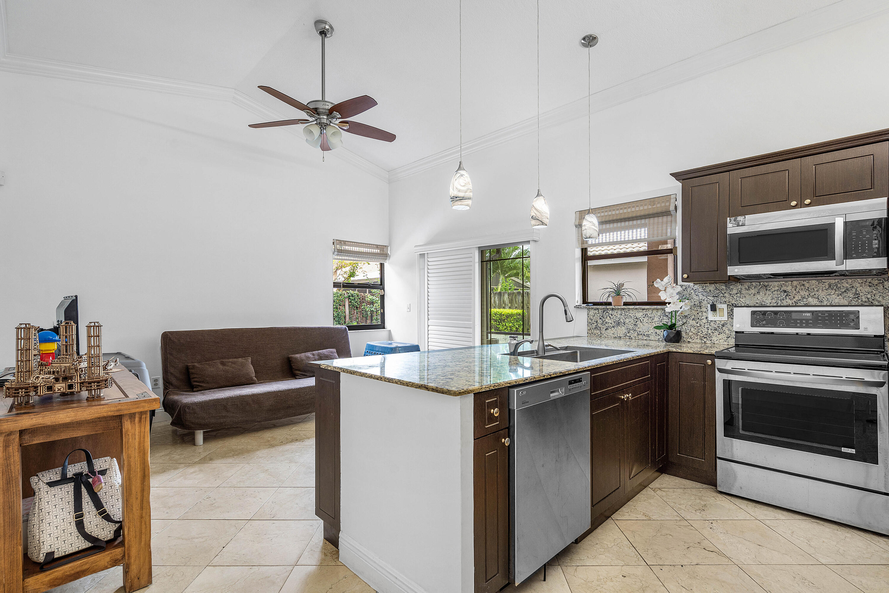6100 Manchester Lane Davie, FL 33331 - Photo 11 of 30 a kitchen with a stove a microwave and a sink
