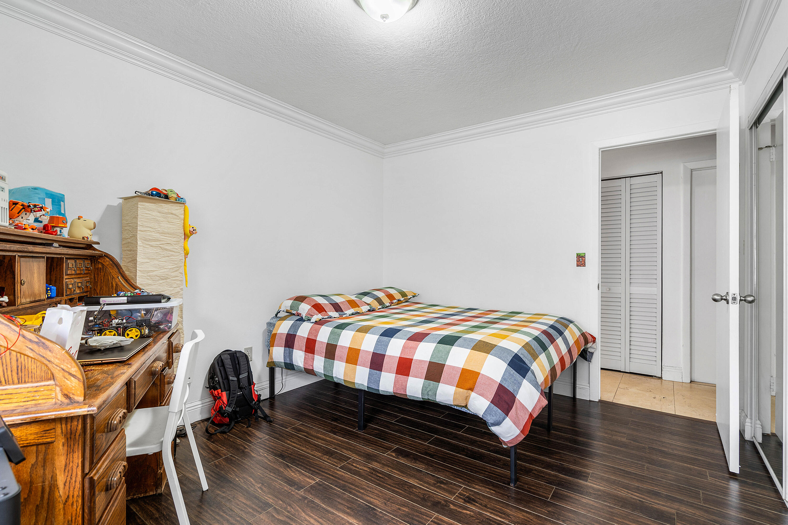 6100 Manchester Lane Davie, FL 33331 - Photo 21 of 30 a bedroom with a bed and wooden floor