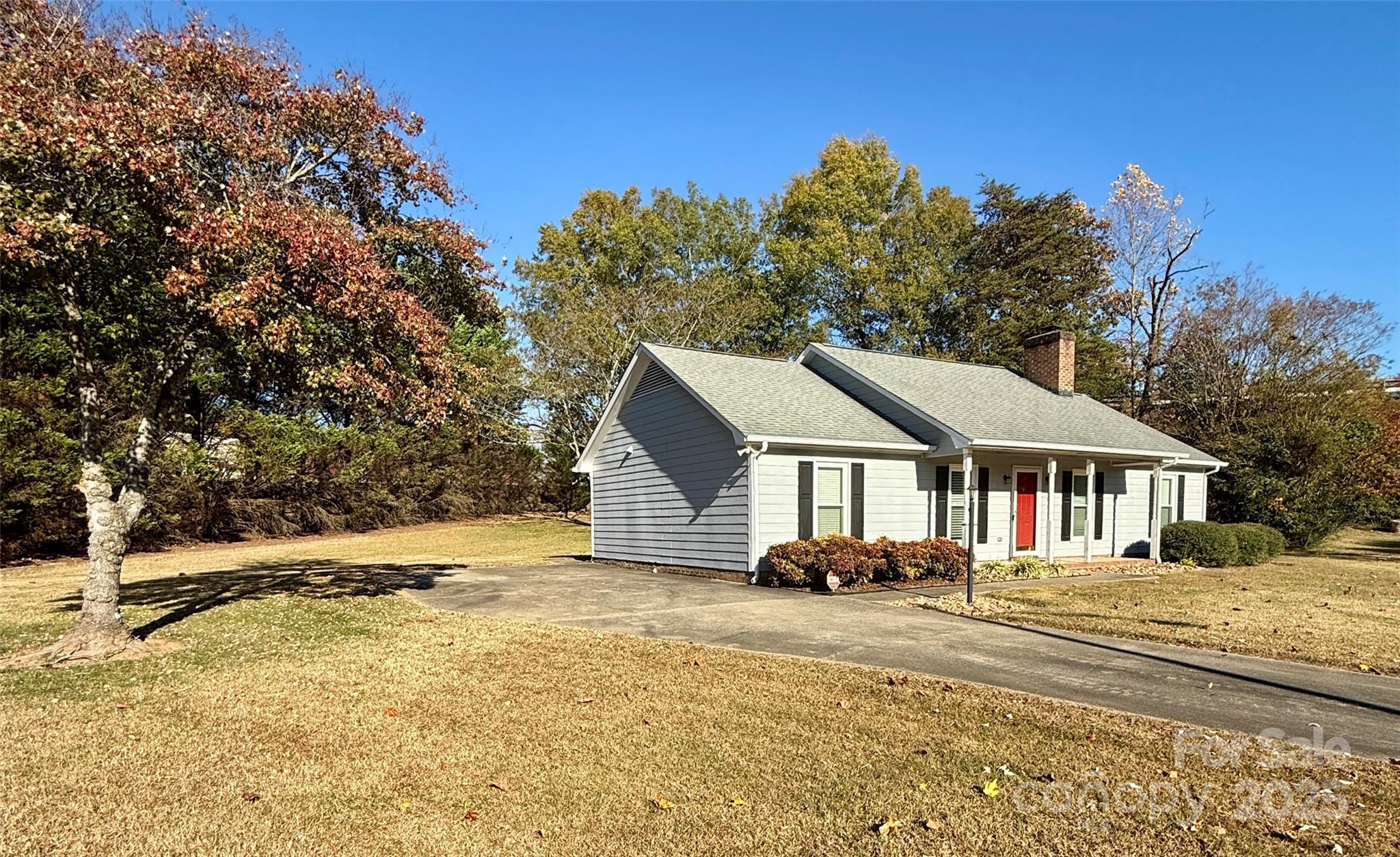 2238 Swain Court Gastonia, NC 28054 - Photo 24 of 27 a front view of a house with a yard covered with snow and trees
