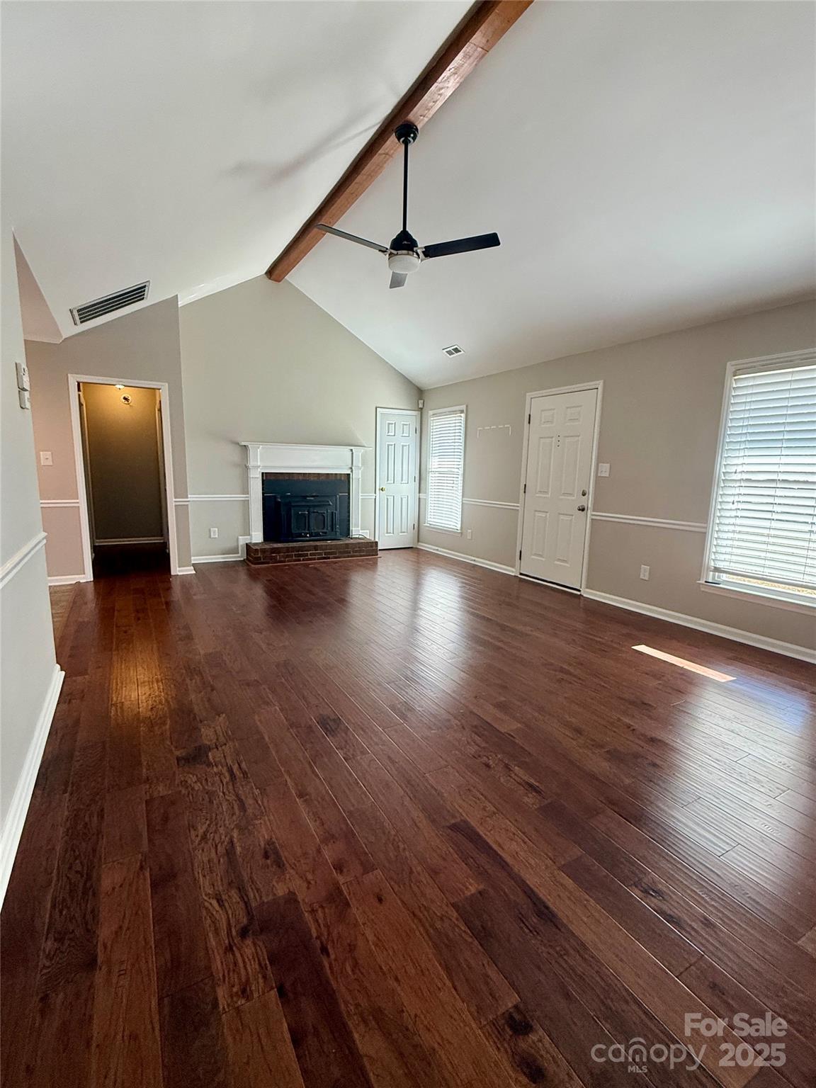 2238 Swain Court Gastonia, NC 28054 - Photo 5 of 27 a view of a livingroom with wooden floor and a ceiling fan