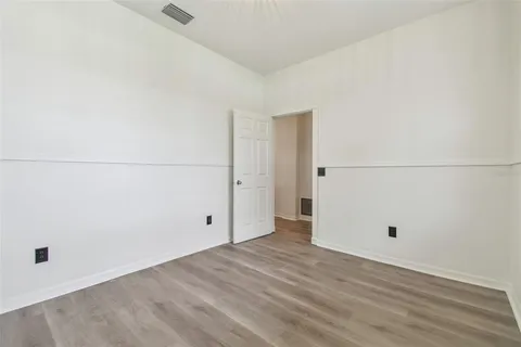 a view of a room with wooden floor