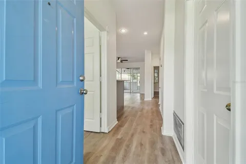 a view of a hallway with wooden floor