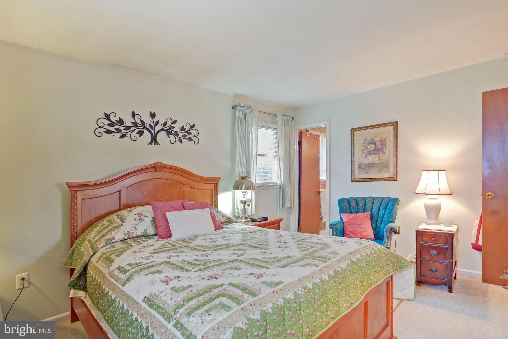 3644 Water Tank Road Manchester, MD 21102 - Photo 13 of 37 a bedroom with a bed and a chandelier