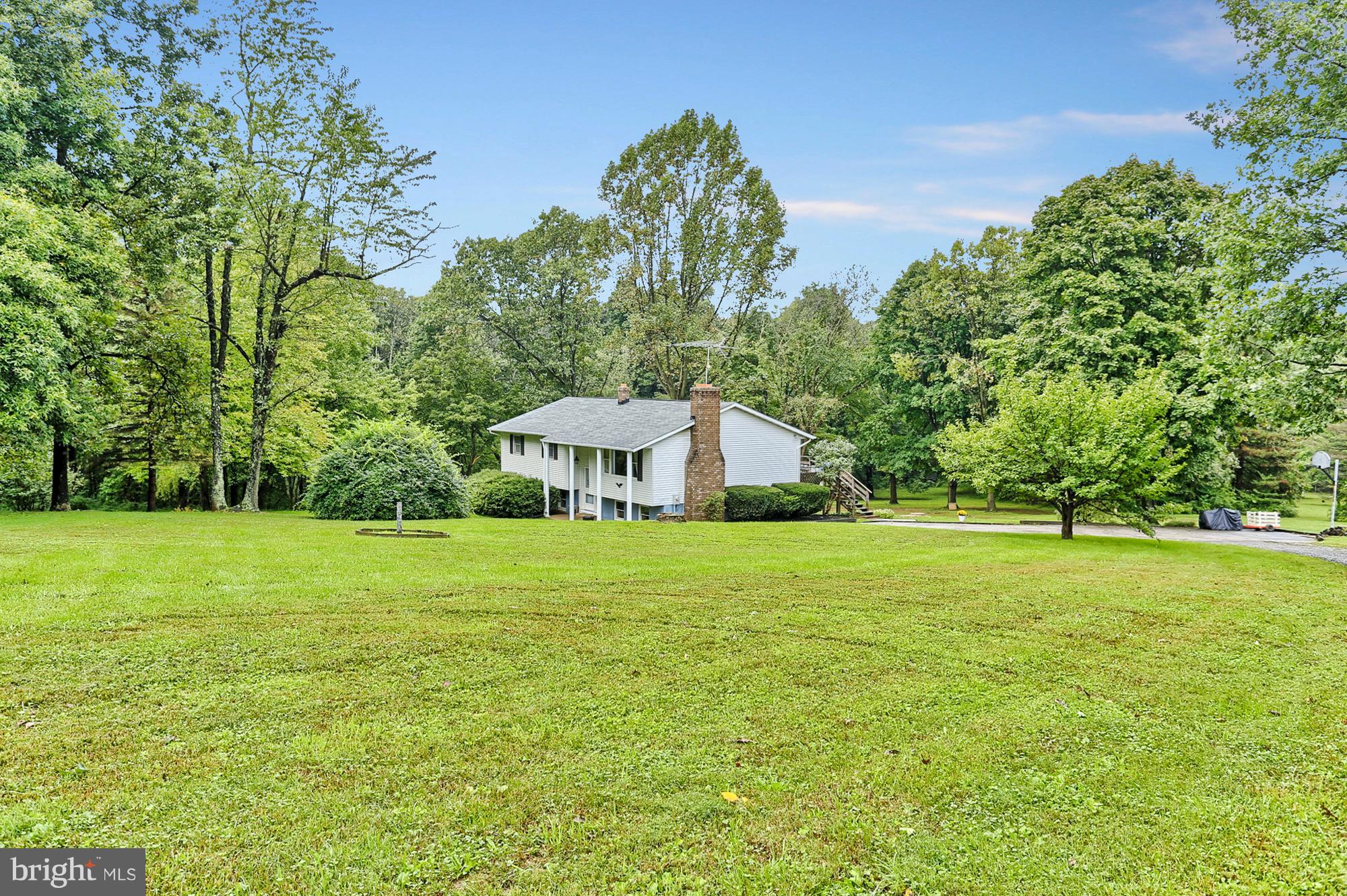 3644 Water Tank Road Manchester, MD 21102 - Photo 28 of 37 a view of a big yard with a house and large trees