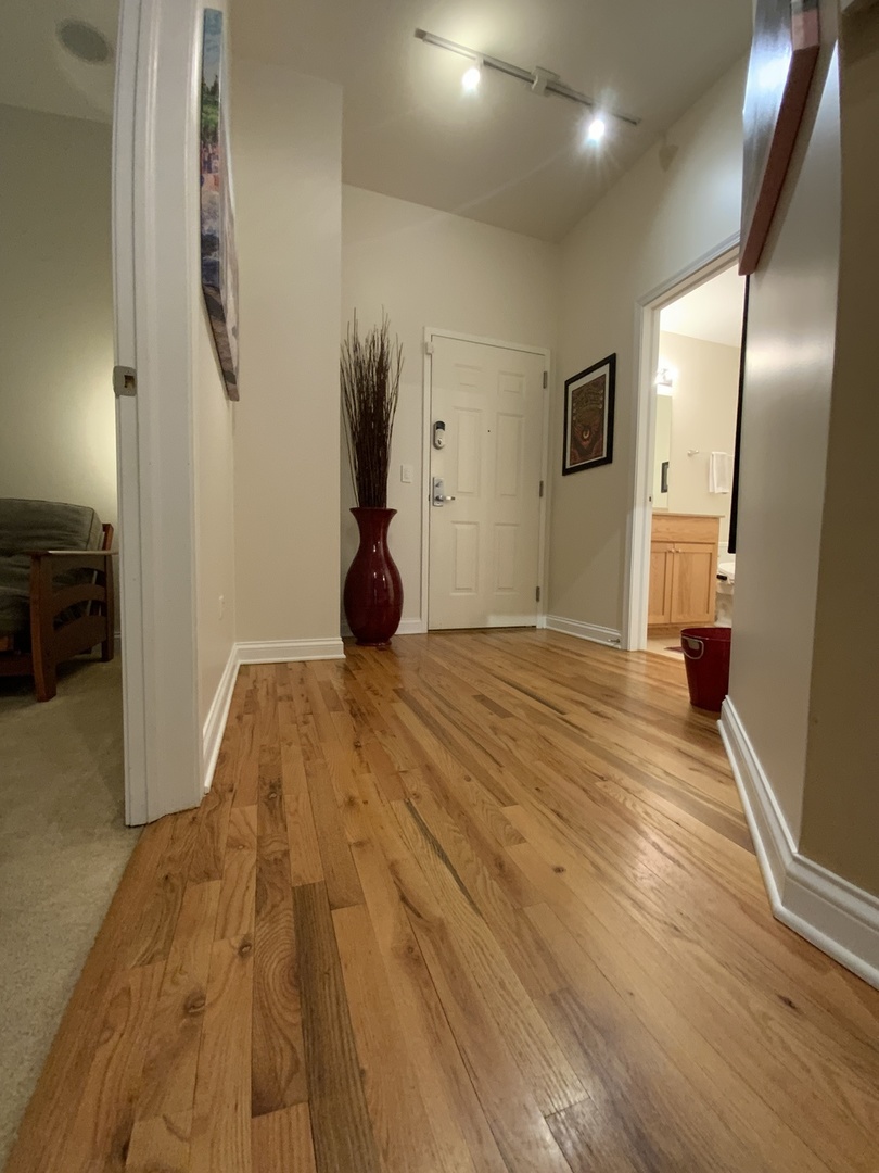 2025 South Indiana Avenue, Unit 209 Chicago, IL 60616 - Photo 17 of 49 a bedroom with a bed and a flat screen tv