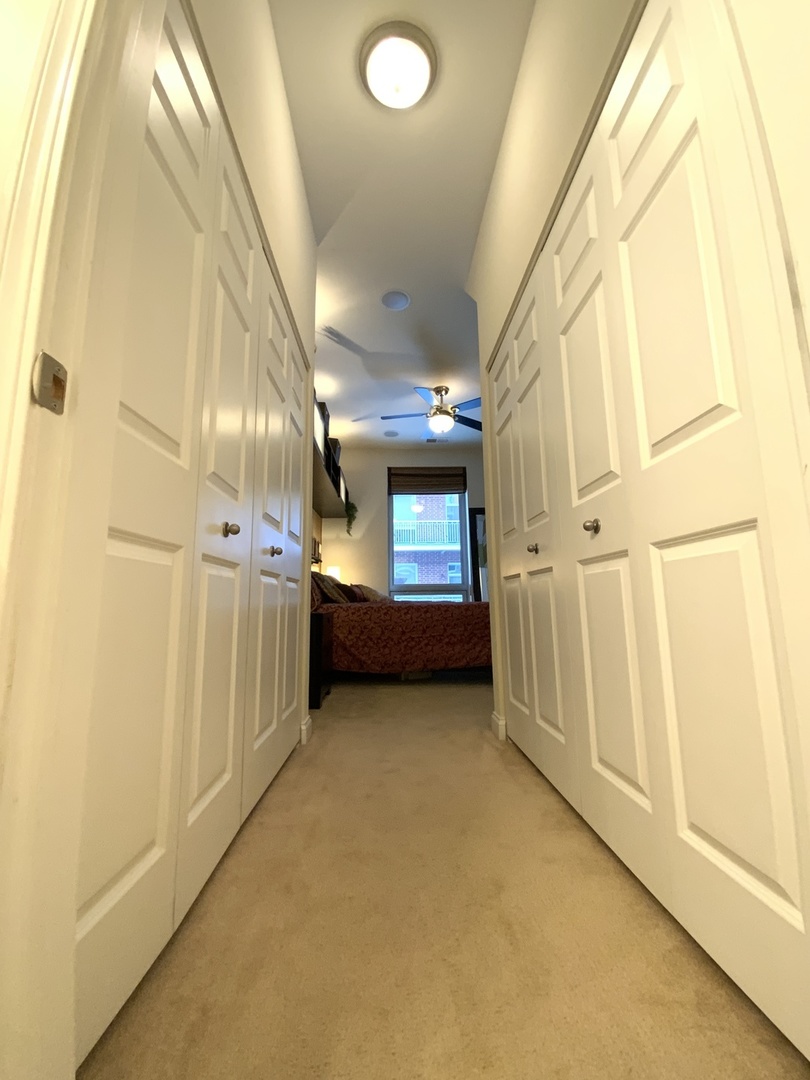 2025 South Indiana Avenue, Unit 209 Chicago, IL 60616 - Photo 35 of 49 a view of a hallway with wooden floors
