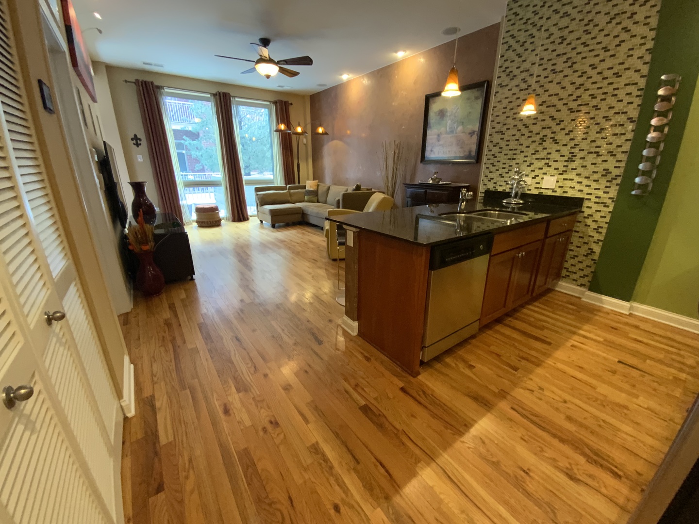 2025 South Indiana Avenue, Unit 209 Chicago, IL 60616 - Photo 36 of 49 a kitchen with granite countertop a sink dishwasher a refrigerator and wooden floor