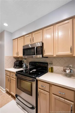 a kitchen with stainless steel appliances a sink stove and cabinets