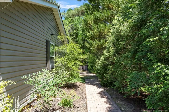 a view of a backyard with large trees