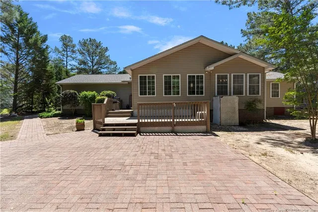 a view of a house with a small yard and wooden fence