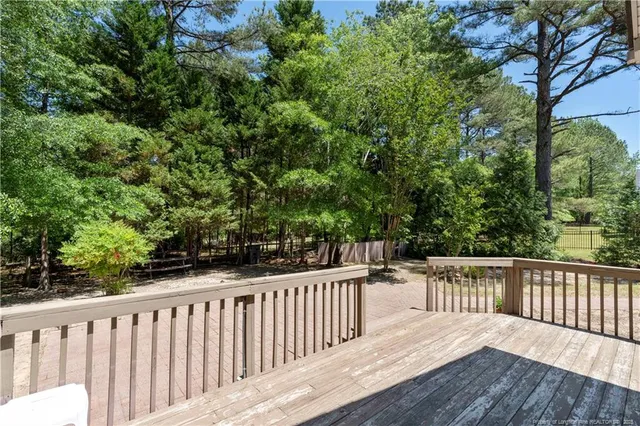 a balcony with wooden floor and outdoor seating