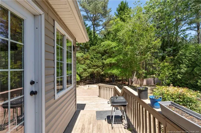 a front view of a house with a yard covered with snow in front of house