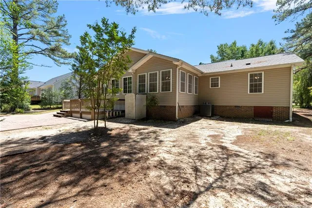 a view of a yard with plants and trees