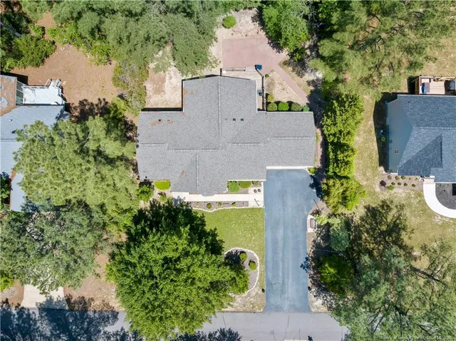 an aerial view of a house with a yard and lake view