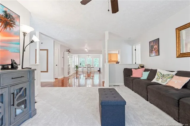 a view of a a dining room with furniture window and wooden floor