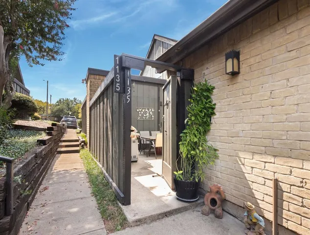 a view of a path along with potted plants