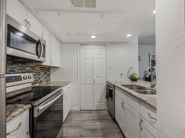 a kitchen counter with a sink and a chandelier