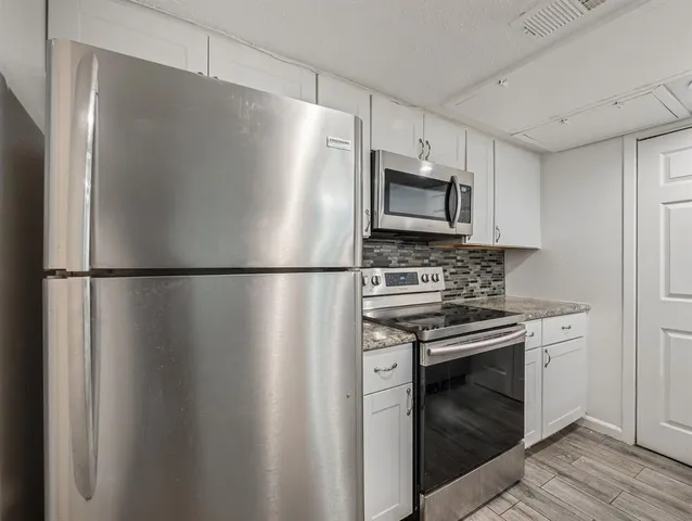 a kitchen with a sink stove and cabinets