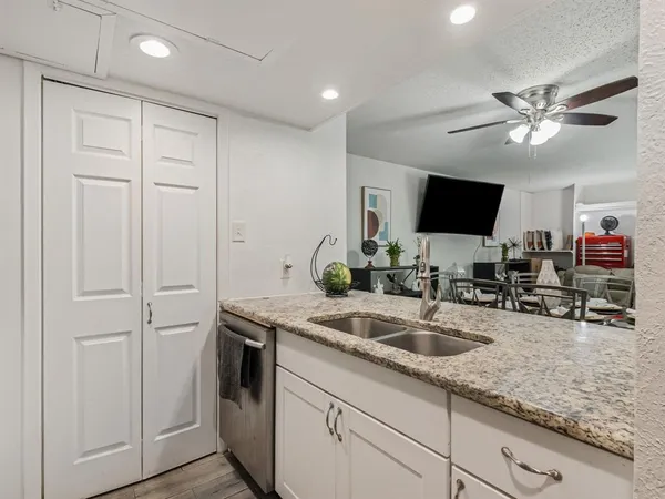 a kitchen with stainless steel appliances granite countertop a refrigerator and a stove top oven