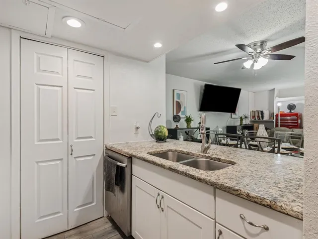 a kitchen with stainless steel appliances granite countertop a refrigerator and a stove top oven