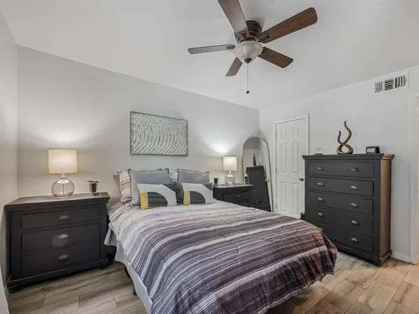 a kitchen with stainless steel appliances granite countertop a sink and a stove with wooden floor