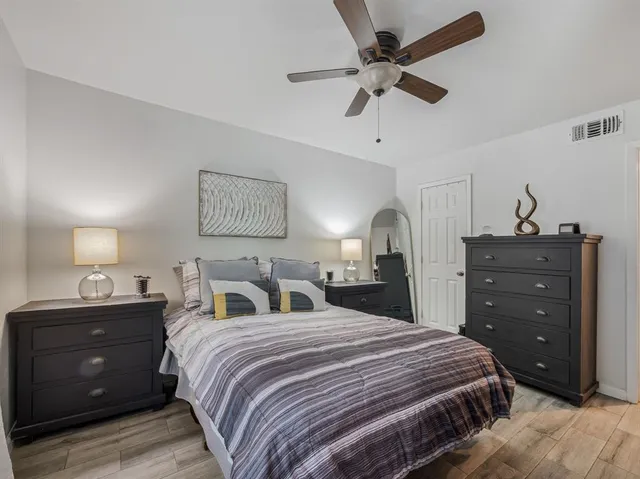 a kitchen with stainless steel appliances granite countertop a sink and a stove with wooden floor