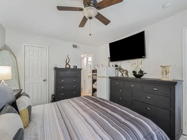 a bedroom with a bed and a dresser