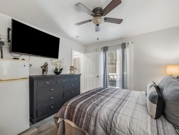 a bedroom with a bed and a flat screen tv