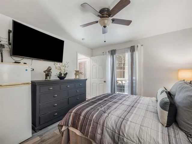 a bedroom with a bed and a flat screen tv