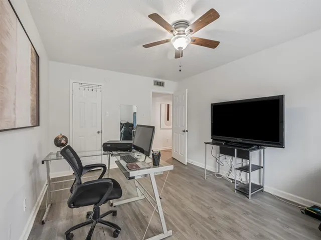a view of a livingroom with furniture and a flat screen tv