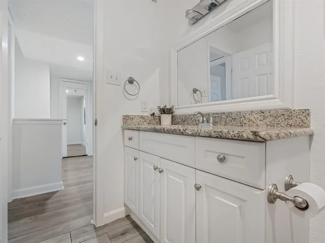 a view of a livingroom with workspace and a flat screen tv