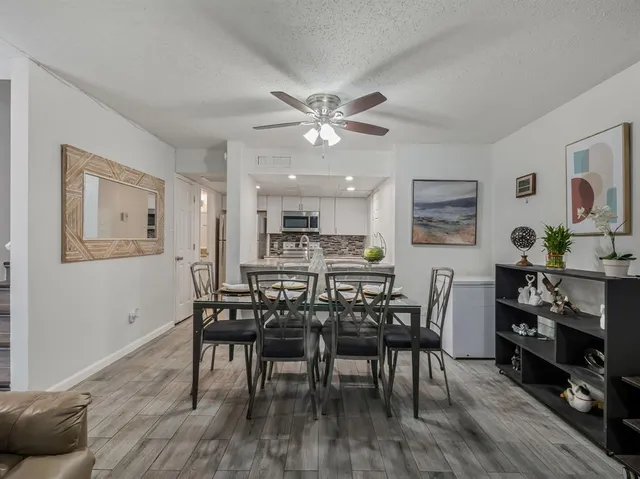 a view of a dining room with furniture and wooden floor