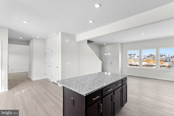 a view of kitchen with sink and refrigerator