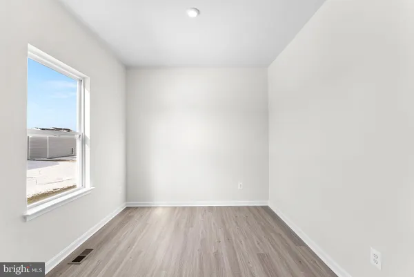 a view of a kitchen with wooden floor and a sink