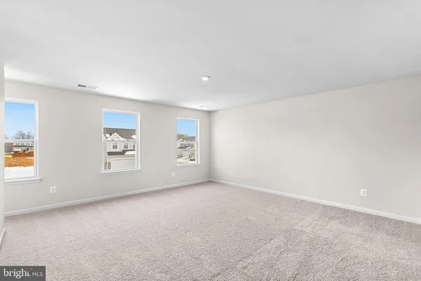 a bedroom with a large bed and a night stand