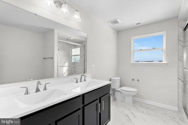 a bathroom with a window and a shower