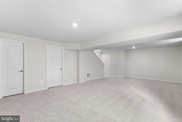 a living room with furniture a rug and a window