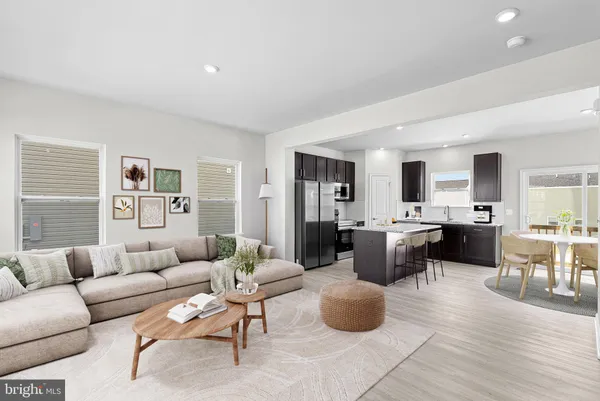 a living room with furniture and view of kitchen