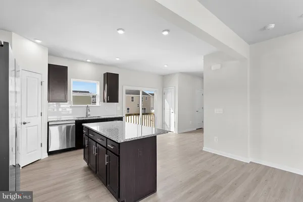 a large kitchen with stainless steel appliances granite countertop a sink and a stove
